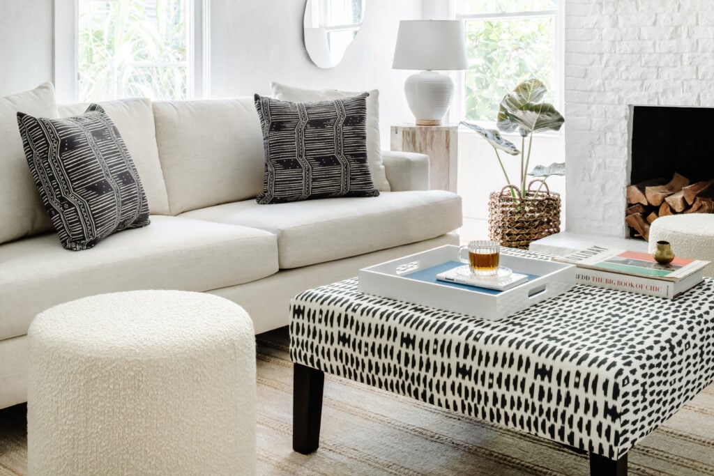 Classic sofa in talc linen in a living room with a cocktail ottoman