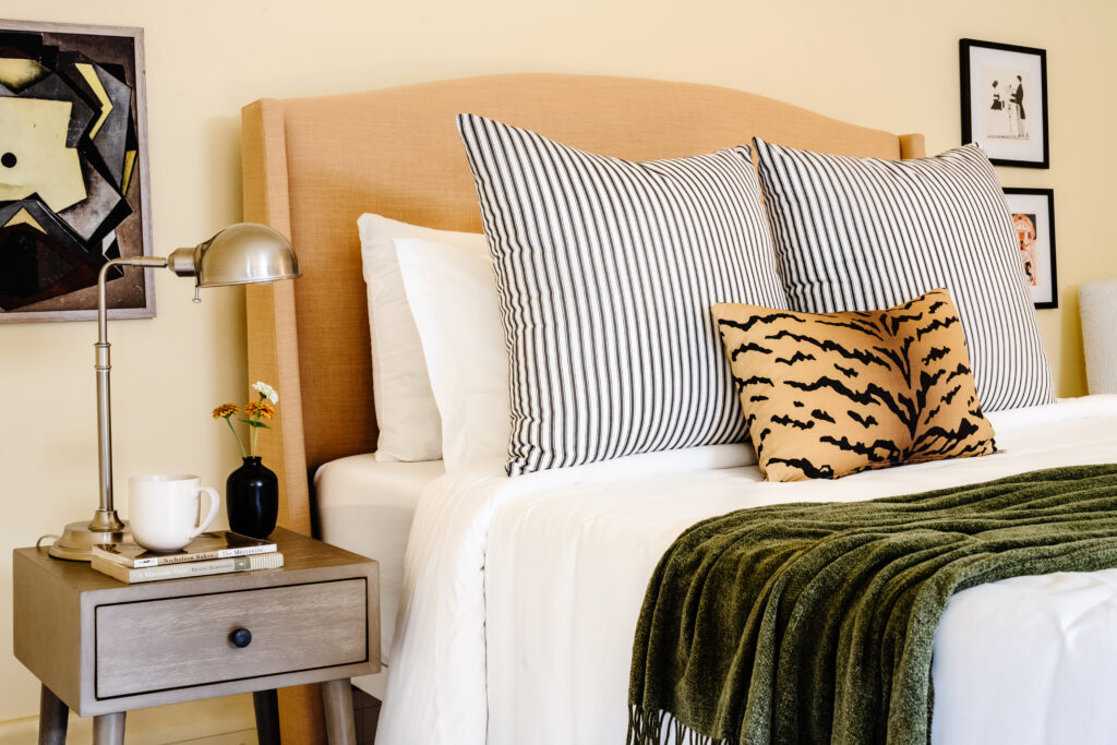 Bed with a lumbar throw pillow in tawny tiger
