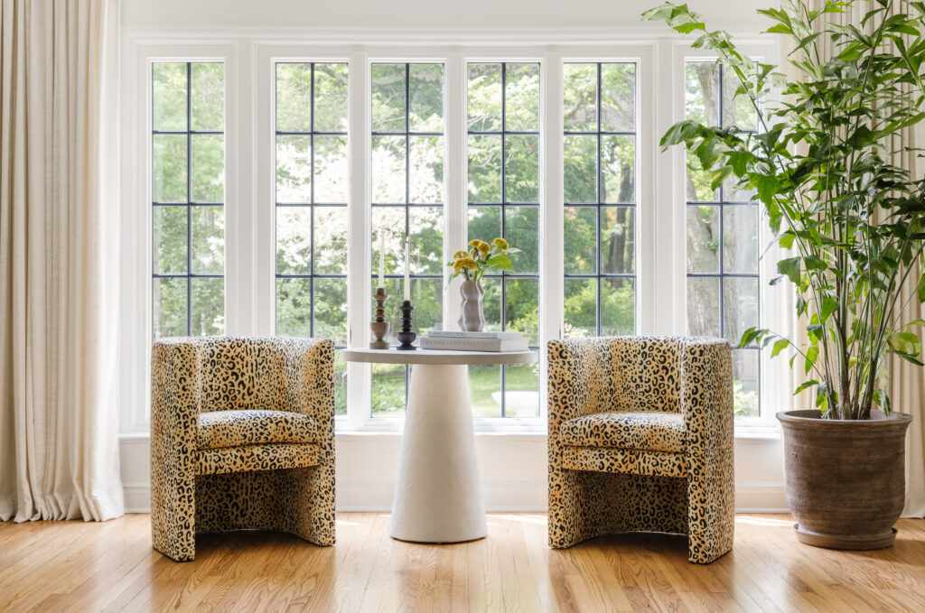 Two leopard print chairs with a table